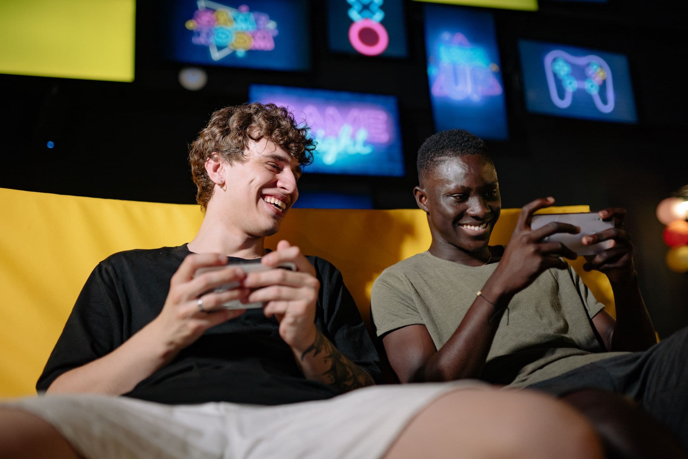 Two players laughing over their phones mid-match